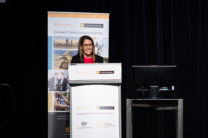 Rebecca Mitchell, Bankwest, standing at a lectern with a BCEC pull up banner behind her